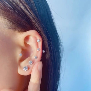 Minimalist silver zircon ball studs on ear showing elegant 6-piece earring set