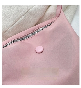 Detail of pink nylon tote bag showing metallic zipper and fine fabric texture