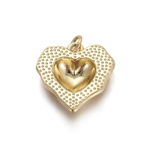 Detailed close-up of a golden heart pendant with a textured border and polished center