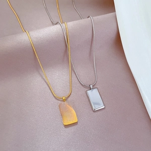 Minimalist gold and silver titanium steel necklaces with wealth-themed bar pendants