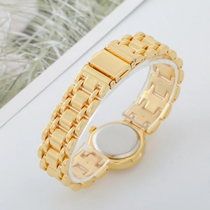 Detailed back view of gold-tone metal watch link strap and stainless steel case back