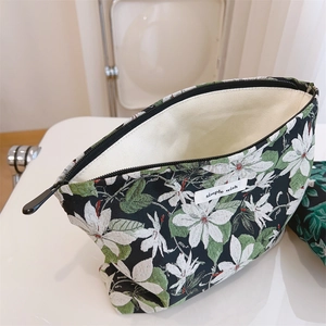 Macro detail of floral canvas makeup bag with vintage pattern and metal zipper closure