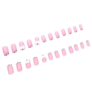 Pink French press-on nails with black polka dots and white 3D bow decorations
