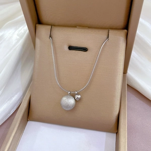 Detailed shot of silver titanium steel necklace with matte and polished spheres