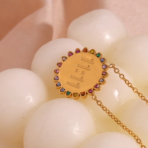 Macro detail of 18K gold plated sunflower pendant featuring 11:11 engraving and colorful zircons