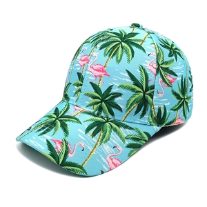 Close-up of tropical print baseball cap with pink flamingo and palm tree patterns