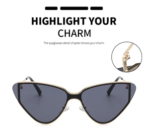 Close-up of reinforced hinges on gold metal cat-eye sunglasses with dark lenses