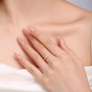 Elegant S925 sterling silver gold ring with three white opals worn by a model