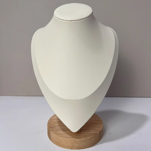 Detail of necklace display bust with cream faux leather finish and solid wood base