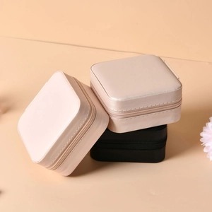 Portable velvet jewelry organizers in pink, champagne, and black with zipper closure