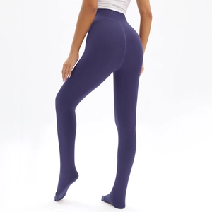 Detail of high waist dark purple thermal leggings with integrated foot for slimming effect