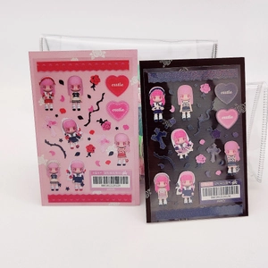 Detail of pink and black anime character stickers for scrapbooking with heart patterns