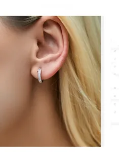 Close-up of S925 sterling silver U-shaped huggie earrings with sparkling CZ stones