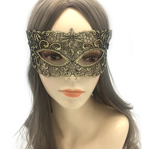 Close-up of golden lace embroidery masquerade mask with intricate hollow patterns