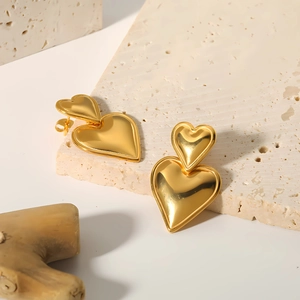 Elegant gold double heart dangle earrings with polished mirror finish for women