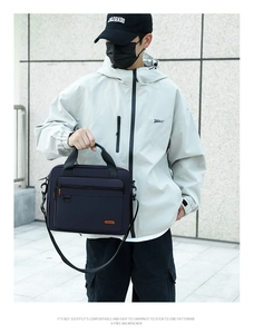 Men's navy blue nylon briefcase held by a model in outdoor business casual setting