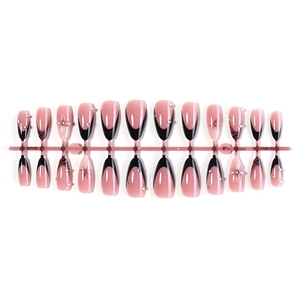French tip almond press-on nails with black borders, floral relief and crystal accents