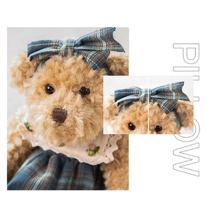 Detailed shot of teddy bear plush in vintage plaid dress with lace embroidery