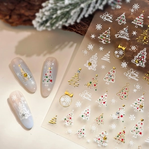 Adesivi per unghie natalizi con fiocchi d'oro e motivi festivi per manicure fai-da-te