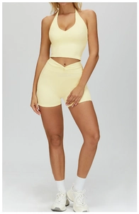 Detail of high-waist yoga shorts with V-shaped gathered waistband and cross-pleated design
