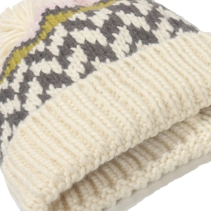 Knit beanie with geometric wave patterns and fluffy pompom for winter warmth