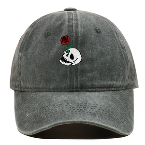 Detailed embroidery of skull and rose on dark gray washed fabric baseball cap
