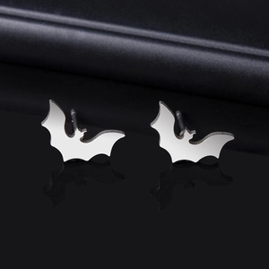 Close-up of silver-toned bat-shaped stud earrings featuring a polished metallic surface