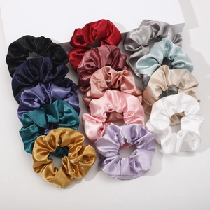 Macro shot of assorted colorful satin scrunchies with elegant silk-like glossy finish