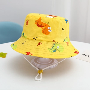 Detail of yellow kids bucket hat featuring cartoon dinosaur prints and adjustable wind cord