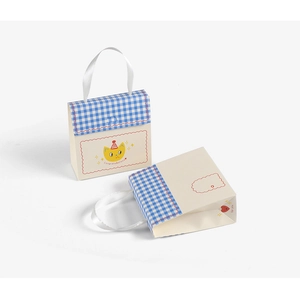 Detail of blue plaid gift box with silk handle and congratulations text for candy