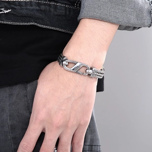 Detail of vintage braided stainless steel bracelet with engraved security clasp for men