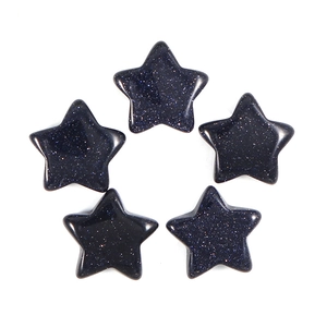 Macro shot of five blue sandstone star-shaped charms with sparkling finish on white background