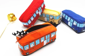 Detailed view of canvas bus-shaped pencil cases with zippers and animal prints