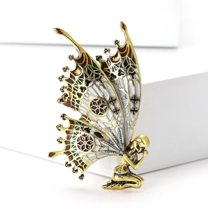 Exquisite kneeling fairy brooch with large enamel butterfly wings in gold and silver finish