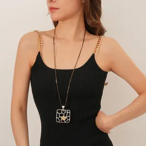 Double-layer necklace with geometric square giraffe pattern pendant on black tank top