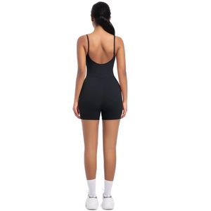 Rear view of black backless yoga bodysuit with thin straps and tight athletic fit