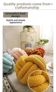 Detail of colorful knotted lamb wool pillows in yellow, pink and teal for home decor