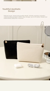 Detail of woven PU leather texture and golden zippers on black and white cosmetic bags