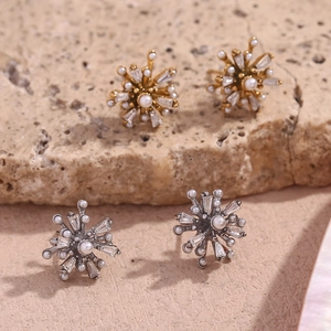 18K gold plated fireworks stud earrings with pearls and crystals on stone background
