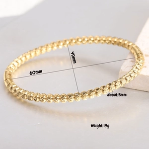 Macro shot of a 5mm gold beaded stainless steel bangle with detailed size dimensions