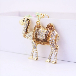 Sparkling crystal camel keychain with golden metal finish and brown enamel details