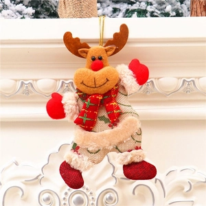 Plush Christmas reindeer hanging ornament with fabric details on white fireplace background