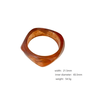 Brown marble pattern resin bangle for women featuring a wide curved minimalist design