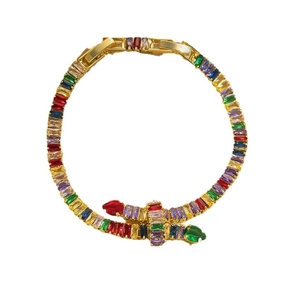 Detail of gold-plated snake bracelet featuring vibrant multi-colored baguette crystals