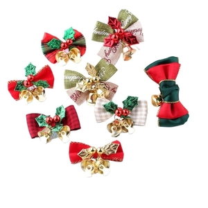 Detailed view of assorted Christmas ribbon bows with gold bells and holly leaf accents