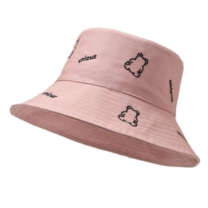 Pink cotton bucket hat with unique embroidery and black bear sketch on white background