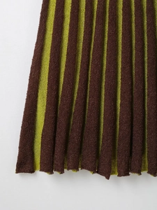 Detailed view of the green and coffee vertical striped knit texture on a sleeveless dress