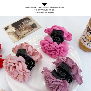 Detail of large realistic rose hair claws in pink and purple with satin petal texture