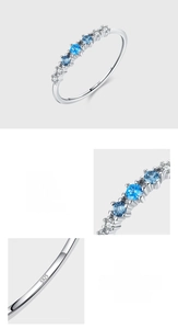 Macro detail of S925 sterling silver ring featuring pave-set blue and white cubic zirconia