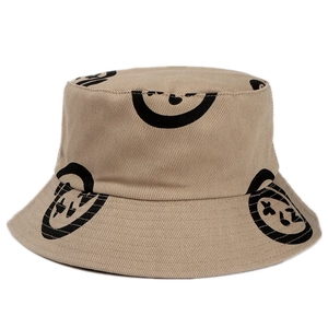 Khaki cotton bucket hat with black abstract smiley prints shown on a white background